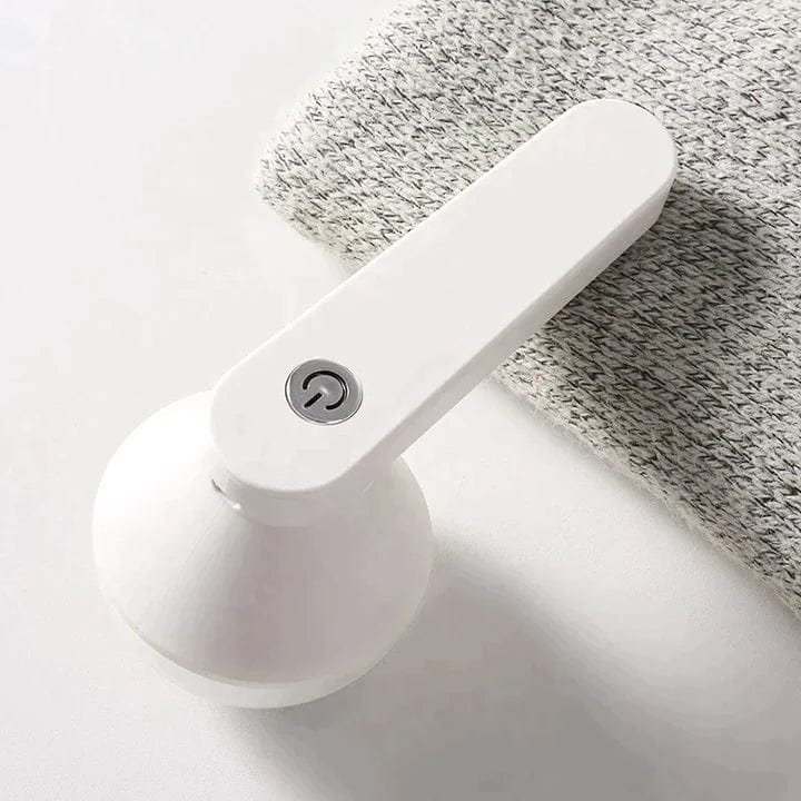 "Draadloze pluizenverwijderaar voor kleding, kleurrijk en compact ontwerp, effectief op diverse stoffen zonder schade."