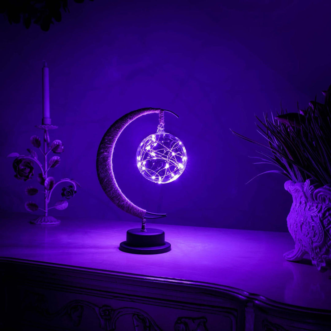 "Dromerige maanlamp van borosilicaatglas met zachte LED-gloed, creëert een betoverende sfeer op tafel."