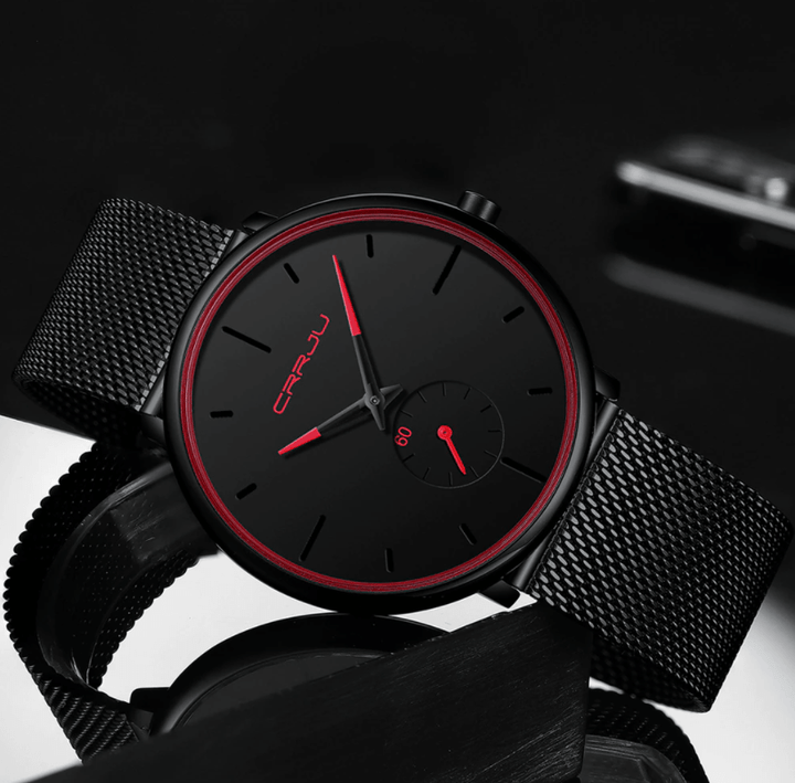 "Dun minimalistisch herenhorloge met elegante zwarte wijzerplaat, roestvrijstalen mesh-band en luxe uitstraling."