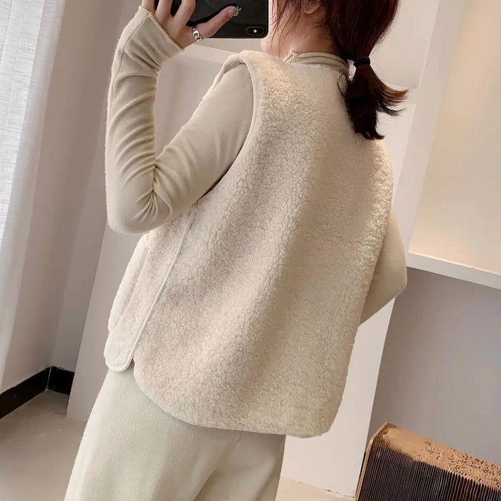 "Elegante dames fleece vest met knoopsluiting en zakken, beige, mouwloos, ideaal voor herfst en winter."