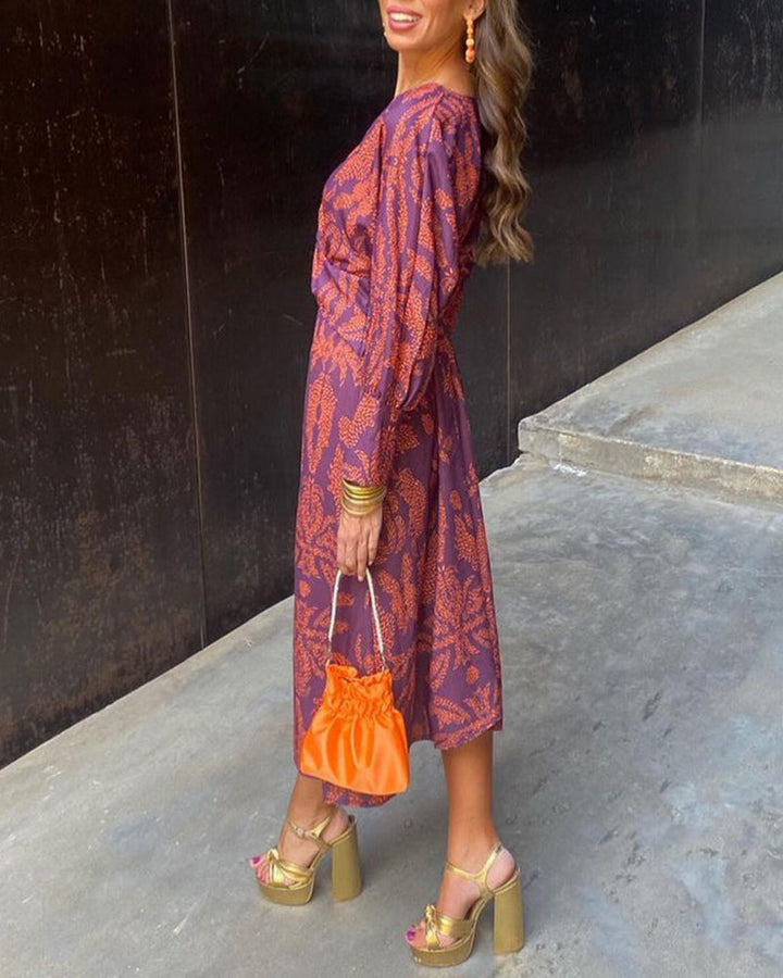 "Elegante dames V-hals midi-jurk met bladerenprint en knoopdetails, lange lantaarnmouwen perfect voor zomerse dagen."