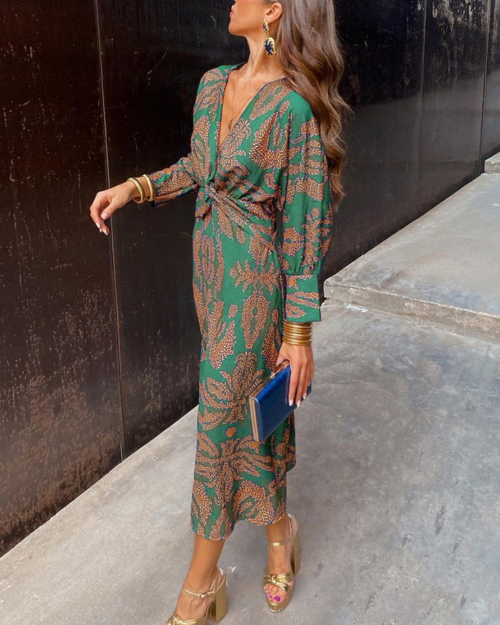 "Elegante dames V-hals midi-jurk met bladerenprint en knoopdetails, lange lantaarnmouwen perfect voor zomerse dagen."