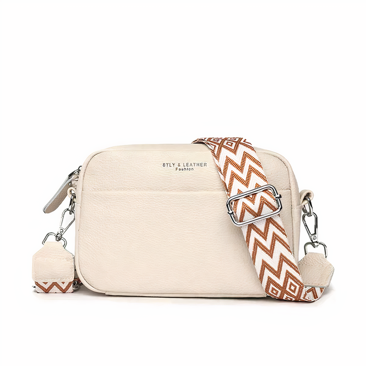 Elegante leren schoudertas voor dames, beige met verstelbare riem en ruime opbergvakken, ideaal voor dagelijks gebruik.
