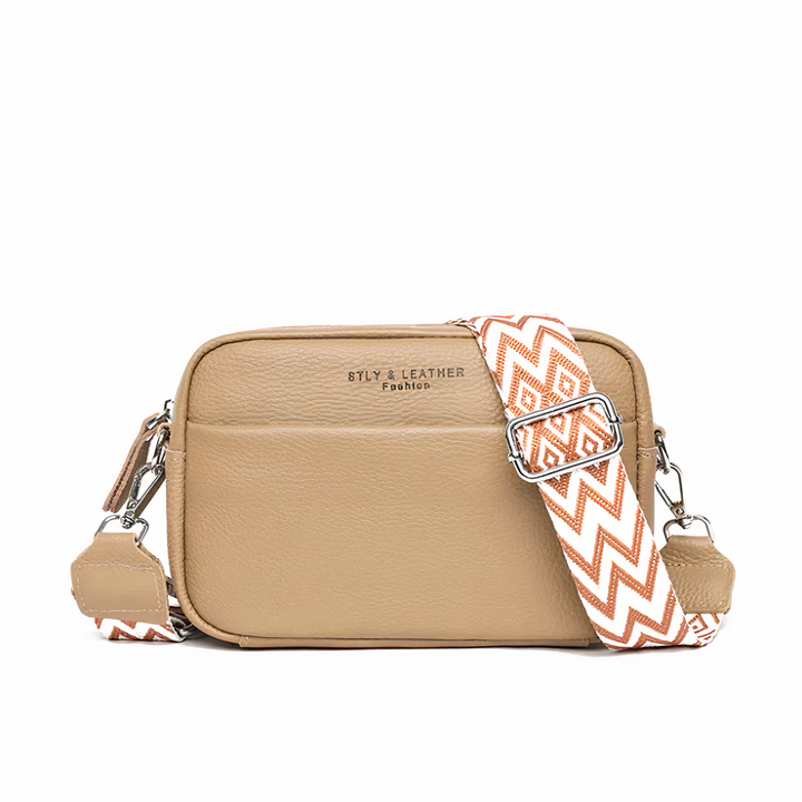 Elegante leren schoudertas voor dames, beige met verstelbare riem en ruime opbergvakken, ideaal voor dagelijks gebruik.