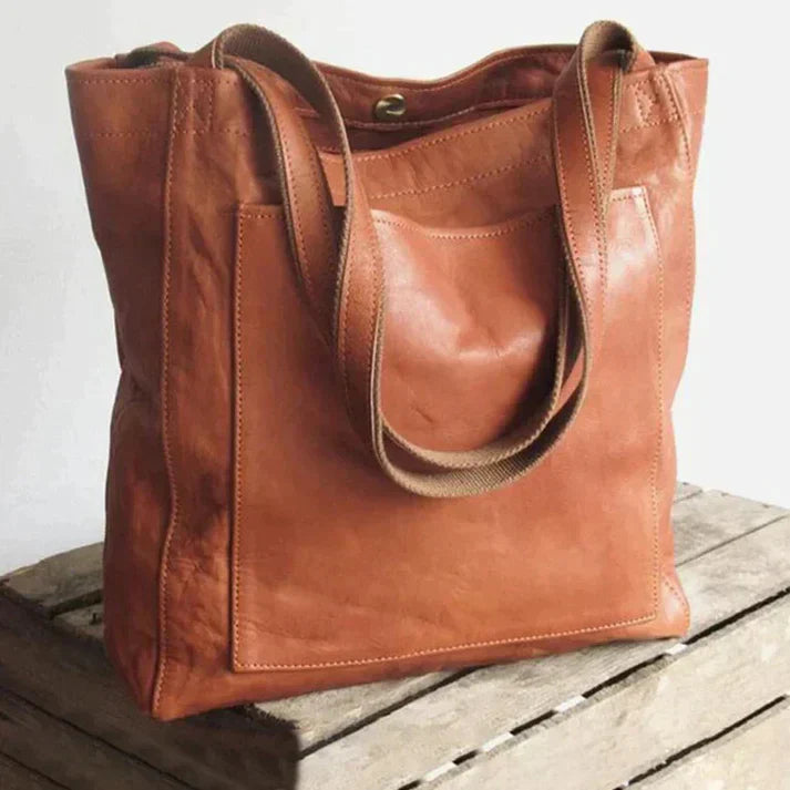 Elegante leren schoudertas voor dames, bruine kleur, met tijdloze uitstraling en royale binnenruimte, geschikt voor elke gele