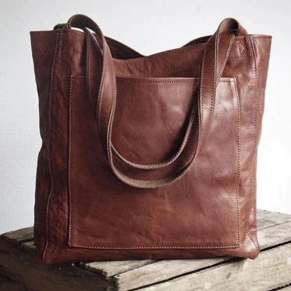 Elegante leren schoudertas voor dames, bruine kleur, met tijdloze uitstraling en royale binnenruimte, geschikt voor elke gele