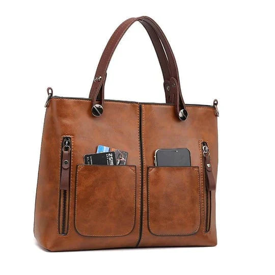 "Elegante vintagestijl leren schoudertas voor dames met bruine tinten, perfect voor een klassieke en tijdloze look."