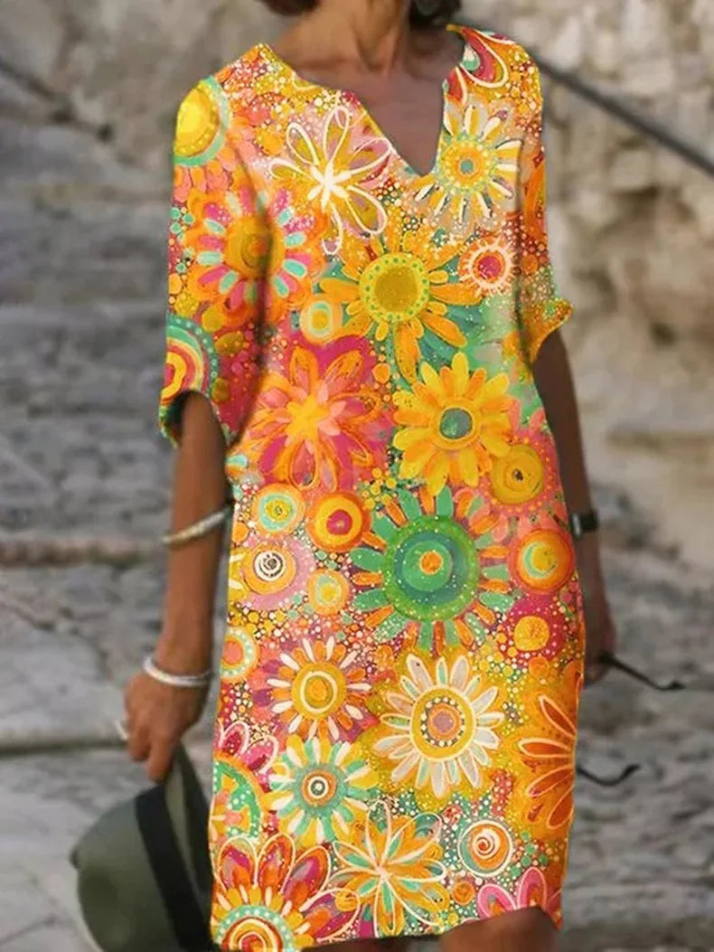 "Elegante zomerjurk dames met levendige bloemenprint en halve mouwen, luchtige stof ideaal voor warme dagen"