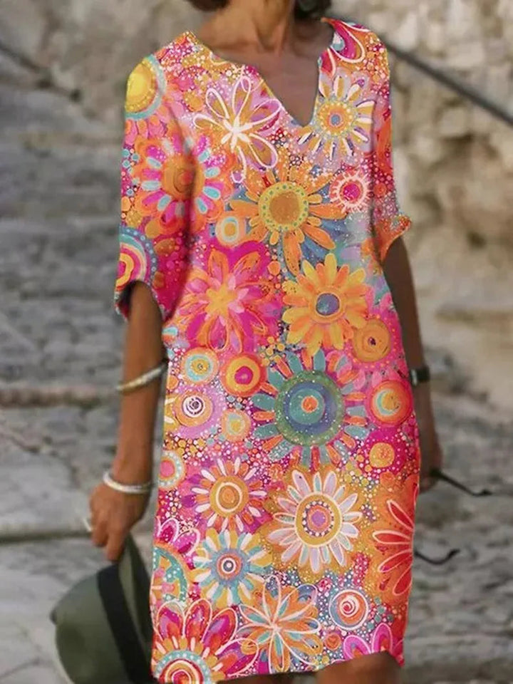 "Elegante zomerjurk dames met levendige bloemenprint en halve mouwen, luchtige stof ideaal voor warme dagen"