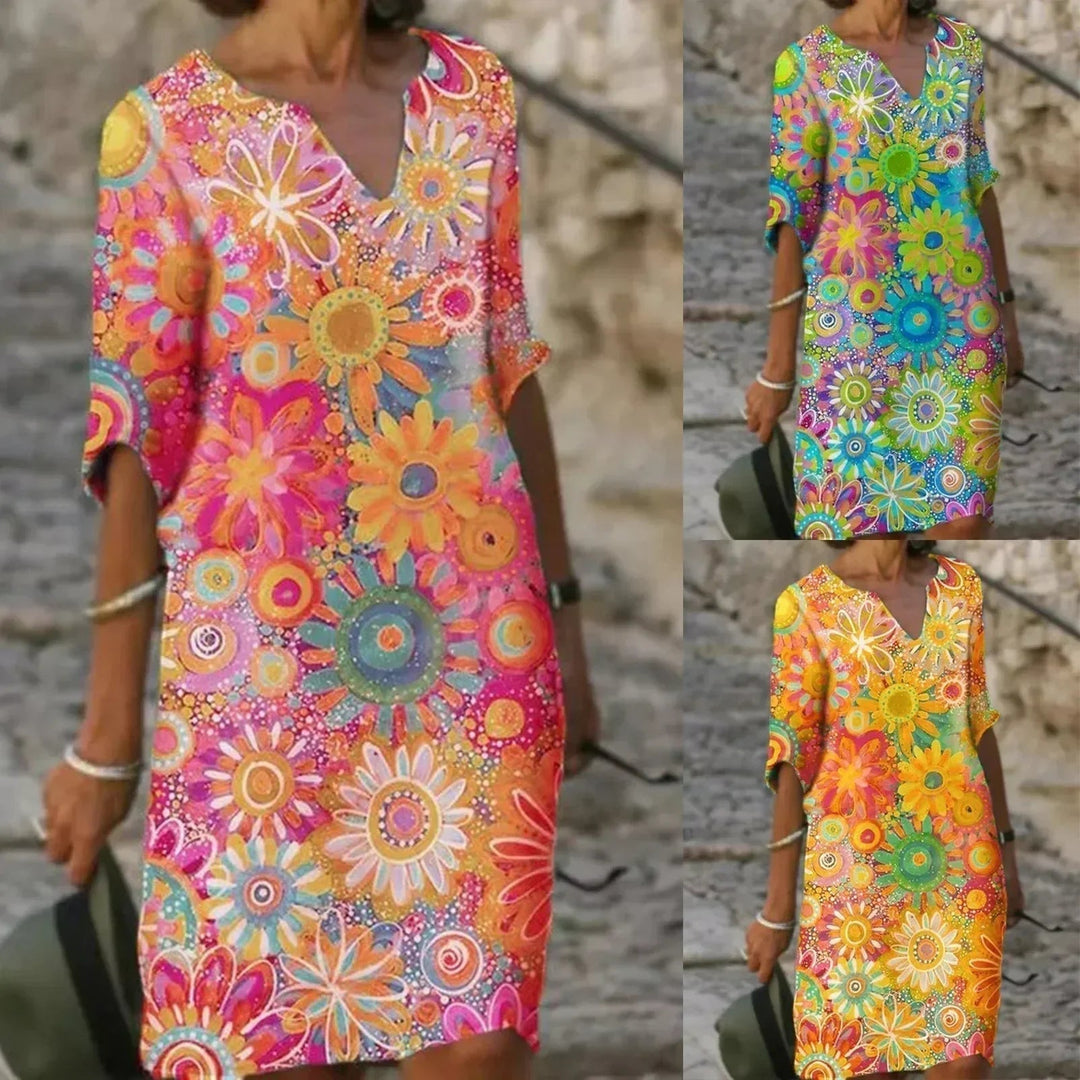 "Elegante zomerjurk dames met levendige bloemenprint en halve mouwen, luchtige stof ideaal voor warme dagen"