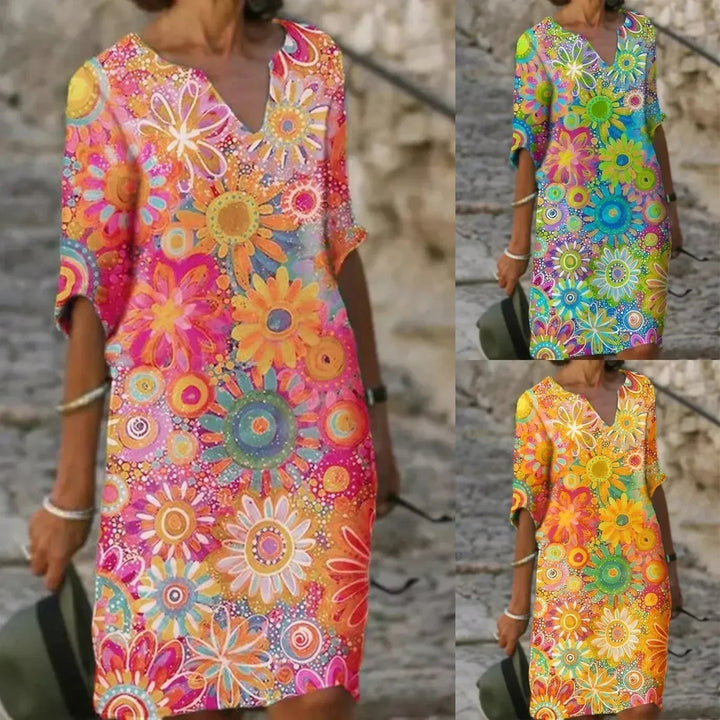 "Elegante zomerjurk dames met levendige bloemenprint en halve mouwen, luchtige stof ideaal voor warme dagen"