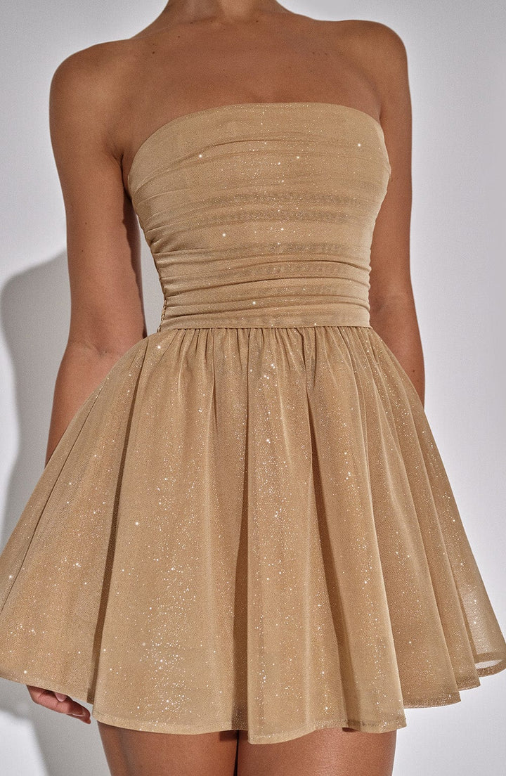 "Glimmende strapless mini-jurk met gouden glitters, flared rok en oversized strik - perfecte partyjurk voor dames."