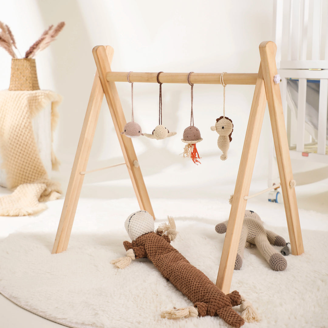 "Houten speelgym voor baby's, educatief en milieuvriendelijk, met kleurrijke dierenhangers en stevige houten constructie."