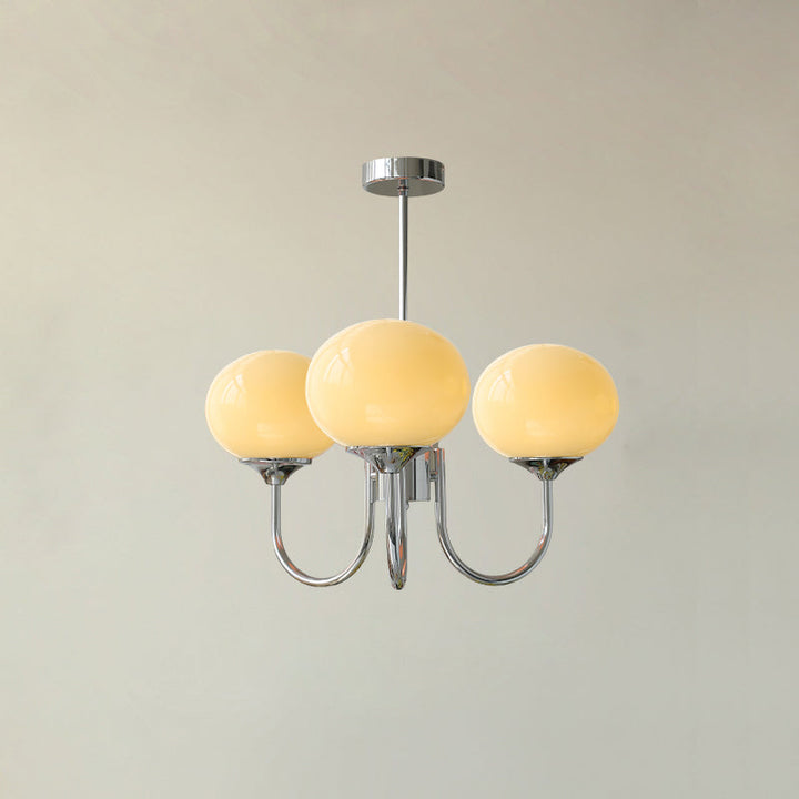 "Moderne kroonluchter met gouden afwerking en roze glazen kappen, geschikt voor LED verlichting in eigentijds interieur."