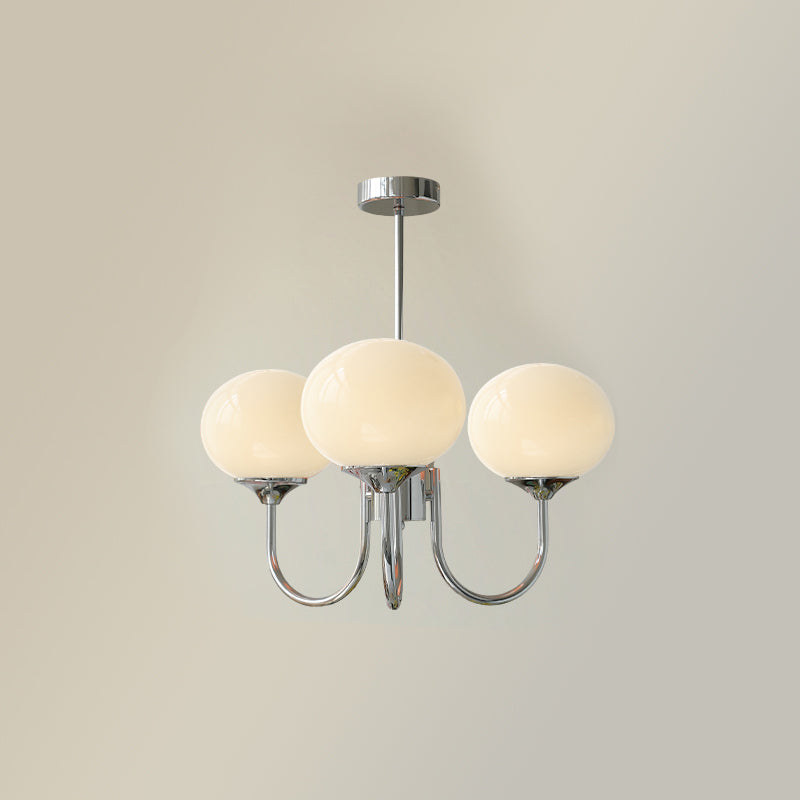 "Moderne kroonluchter met gouden afwerking en roze glazen kappen, geschikt voor LED verlichting in eigentijds interieur."