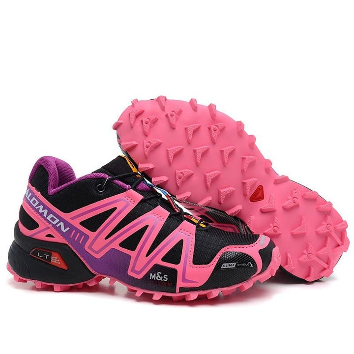 "Robuuste Solamon wandelsneakers met antislipzool en stevige constructie, in wit en zwart, ideaal voor avonturen."