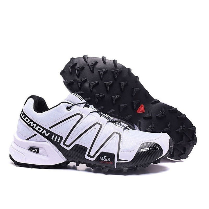 "Robuuste Solamon wandelsneakers met antislipzool en stevige constructie, in wit en zwart, ideaal voor avonturen."