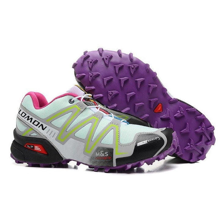 "Robuuste Solamon wandelsneakers met antislipzool en stevige constructie, in wit en zwart, ideaal voor avonturen."