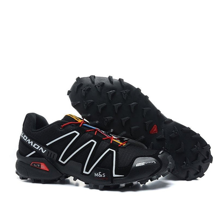 "Robuuste Solamon wandelsneakers met antislipzool en stevige constructie, in wit en zwart, ideaal voor avonturen."