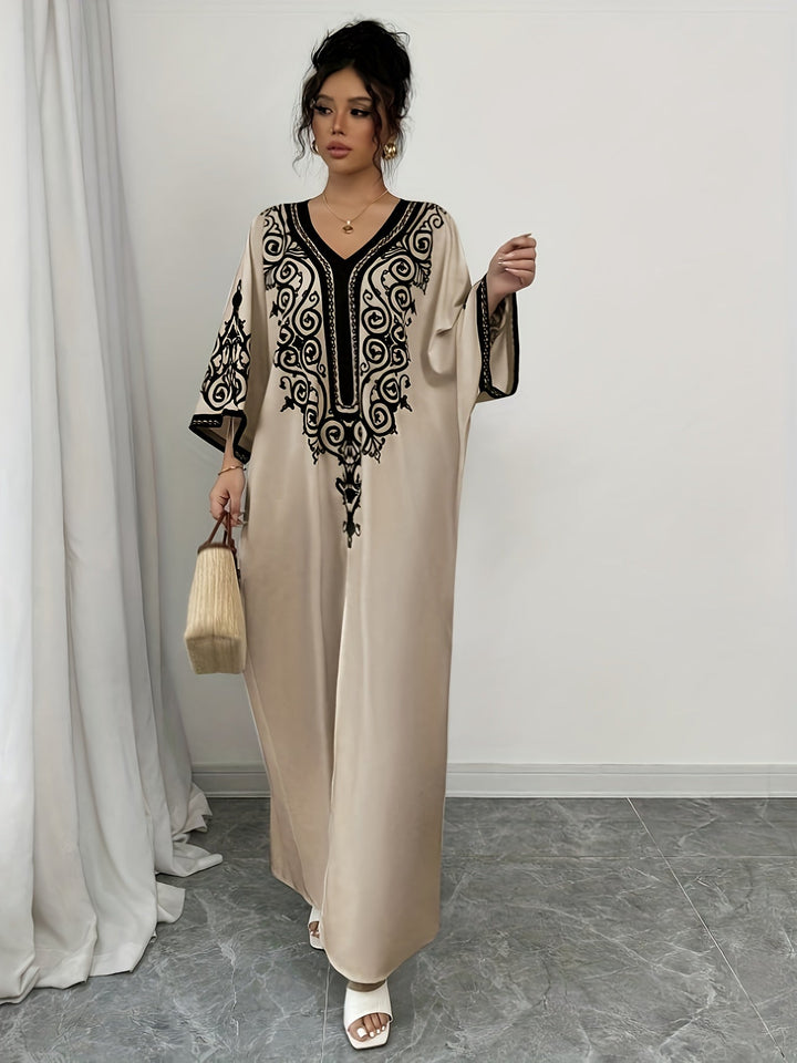 "Stijlvolle abaya jurk met V-hals, lange mouwen en kleurrijke etnische print, voor een elegante en culturele look."