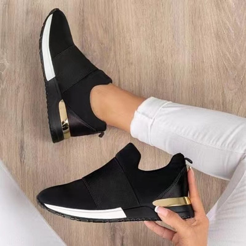 "Stijlvolle beige en rode damessneakers met gouden accenten, ademend bovenwerk en comfortabele pasvorm op houten vloer."