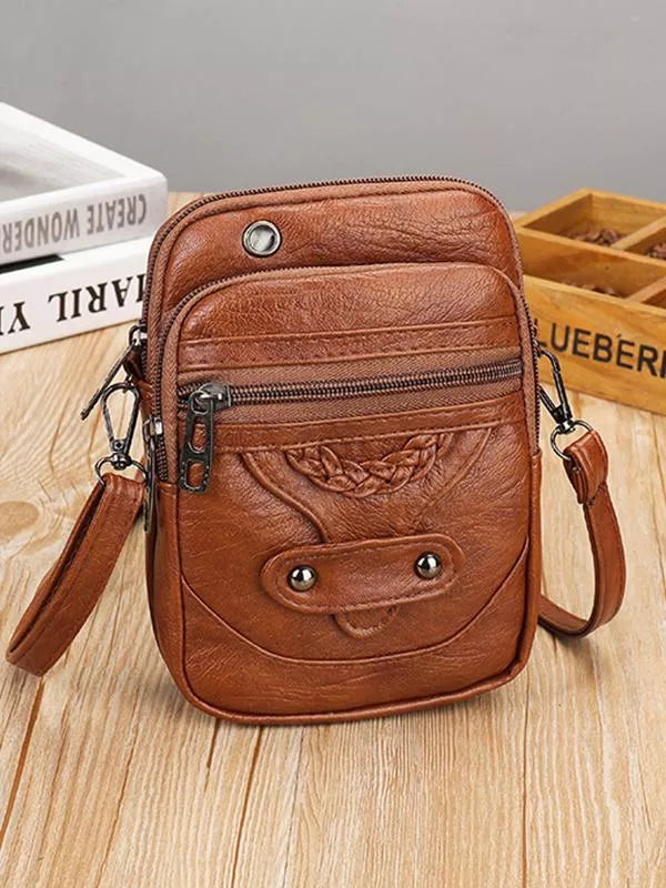 "Vintage leren schoudertas met envelopsluiting, elegant ontwerp, van duurzaam Zwitsers leer met verstelbare riem."