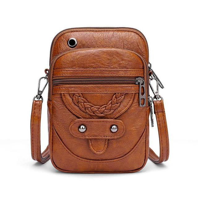 "Vintage leren schoudertas met envelopsluiting, elegant ontwerp, van duurzaam Zwitsers leer met verstelbare riem."