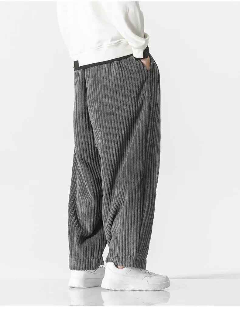 "Zwarte geribbelde relaxed fit broek, corduroy ontwerp, elastische taille, urban stijl, perfect voor casual dagen."